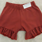 PANTALON CORTO COLOR TEJA VOLANTES